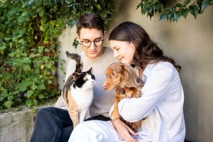 Dog & Cat with their Owner. All of them are happy
